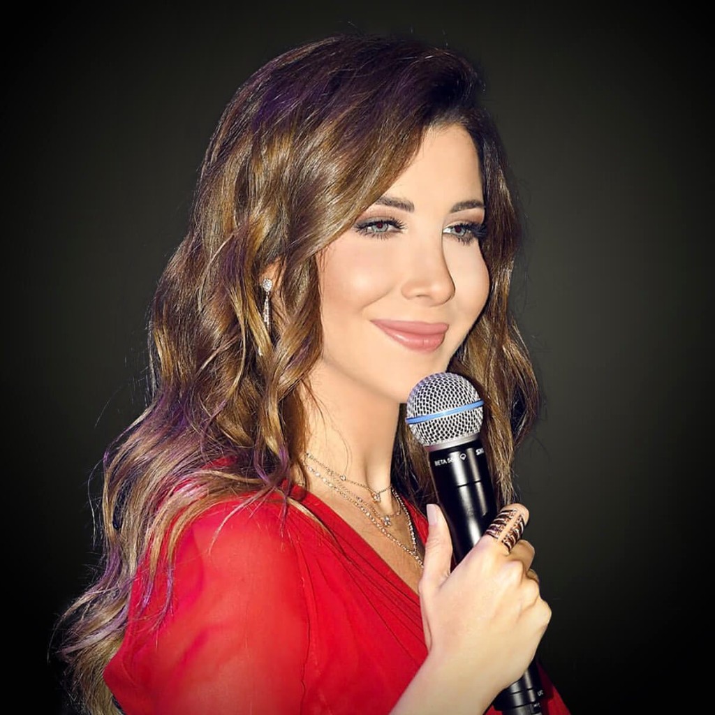 Nancy Ajram with a microphone