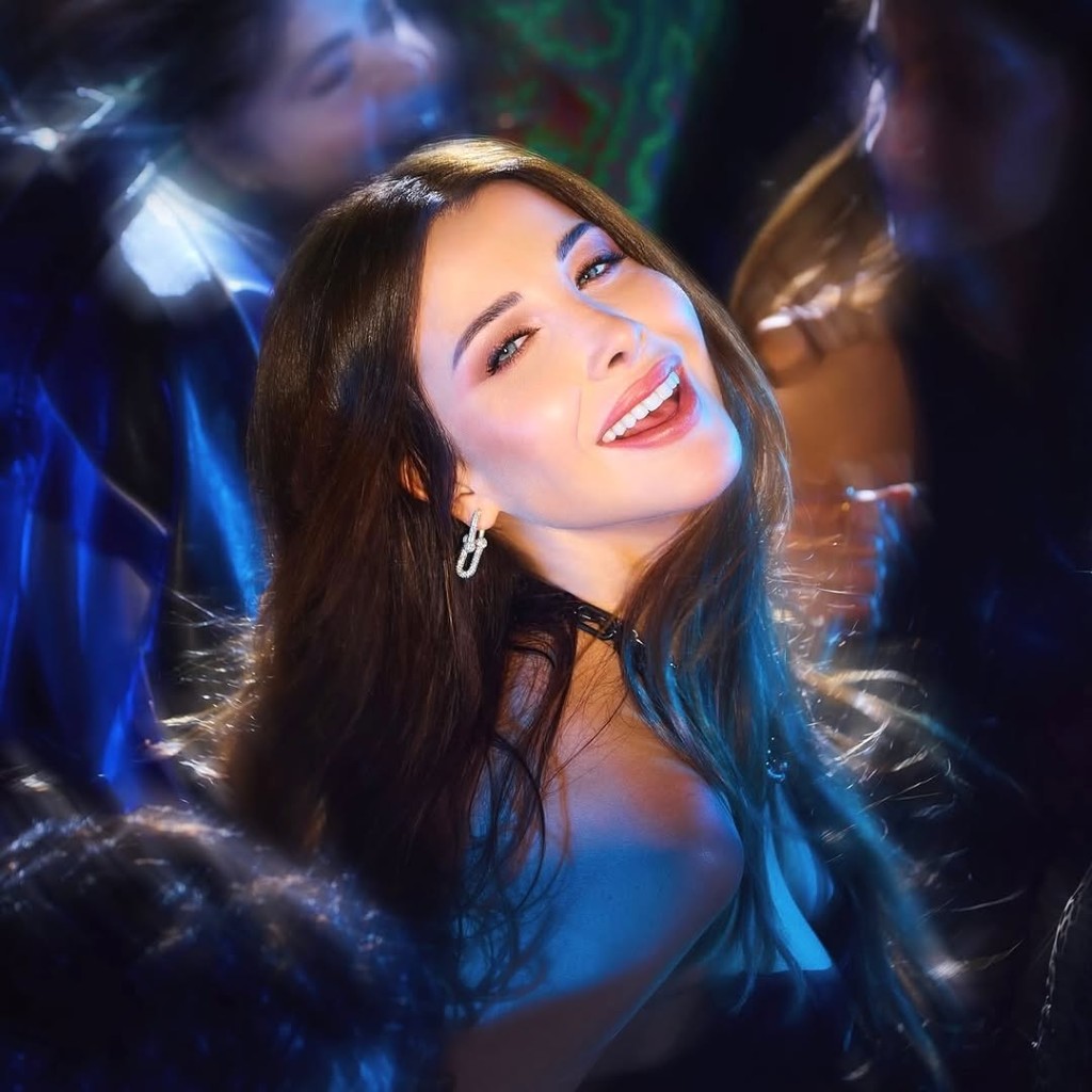Nancy Ajram laughing in blue light